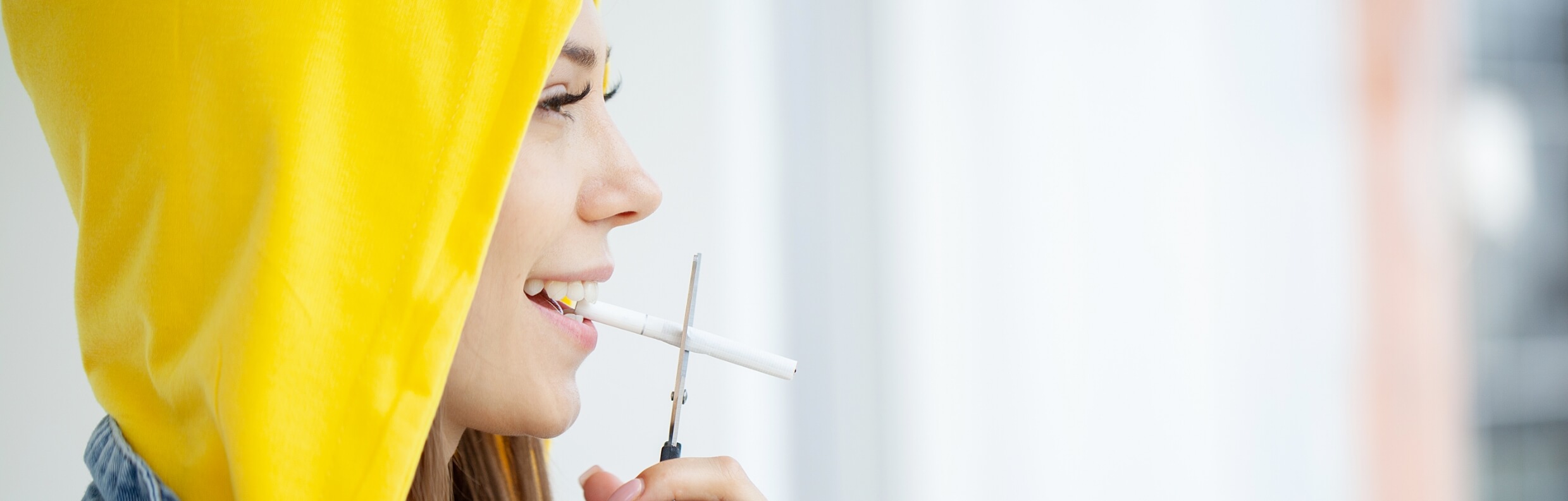 stop-smoking-woman-cuts-a-cigarette-with-scissors-2023-02-01-23-26-17-utc-1