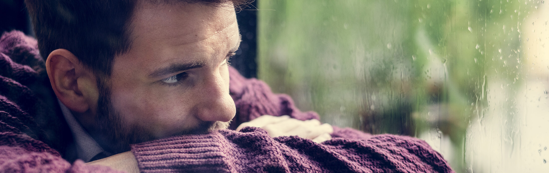 thoughtful-man-looking-out-the-window