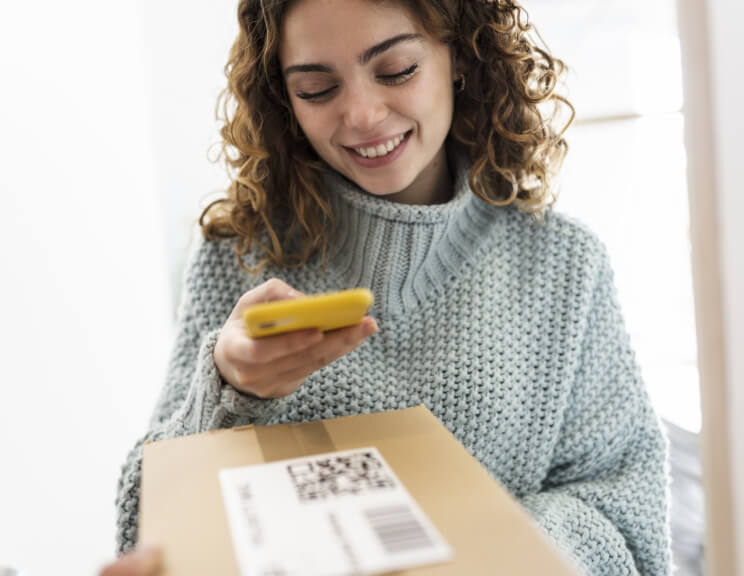 woman-with-c3urly-hair-scanning-a-qr-code-with-her-2022-11-09-05-09-32-utc-1