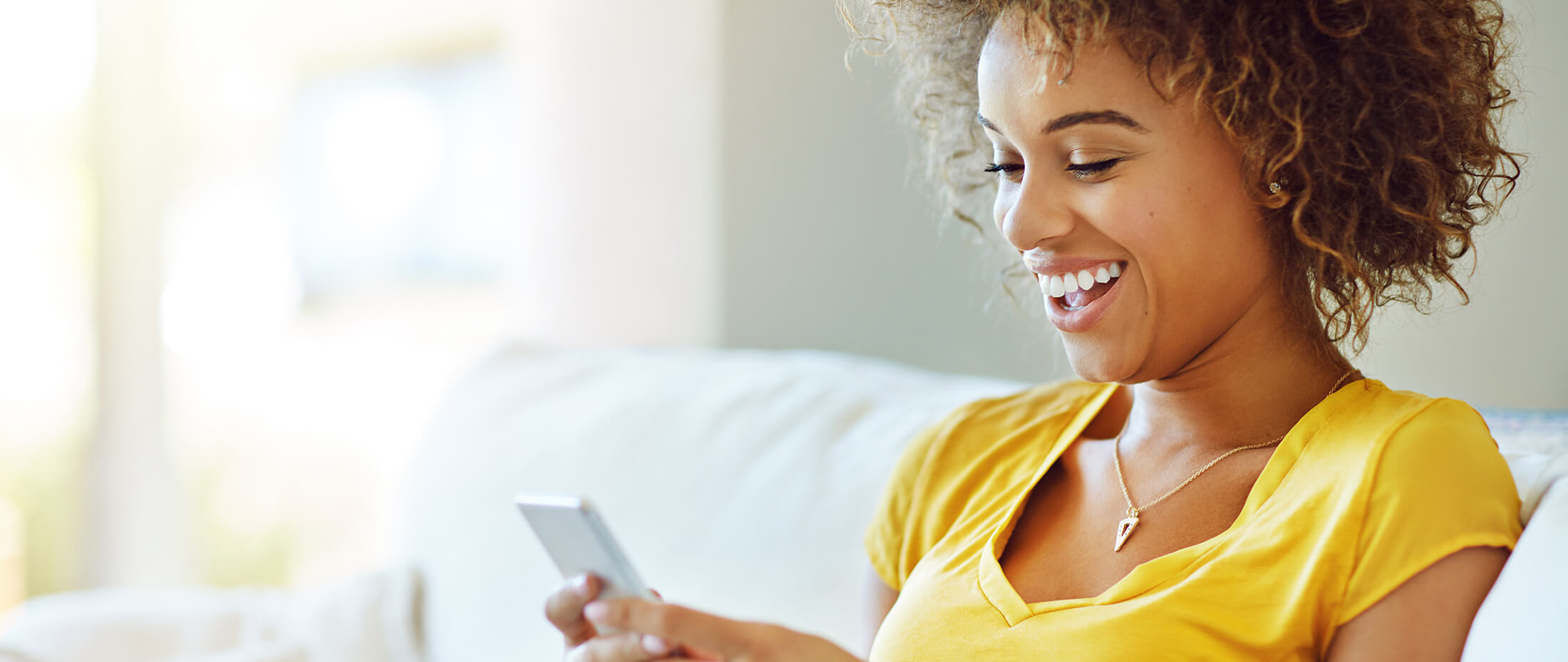 yshot-of-a-young-woman-using-her-phone-on-a-relaxin-2022-12-10-03-54-11-utc-copy-1